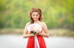 Beautiful Woman Wear Red Evening Dress Hold A Bouquet Of Flowers Stock Photo