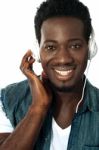 African Man Listening To Music Stock Photo