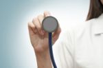 Doctor Holding Stethoscope Stock Photo