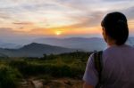 Woman Watching Sunset Stock Photo