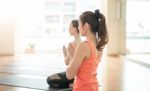 Asian Woman Doing Yoga Indoors Stock Photo