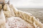 Ice Covered Staircase On The Beach Stock Photo