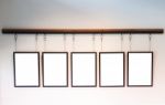 Blank Boards Hanging On White Wall Background Stock Photo