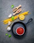 The Thin Spaghetti On Dark Stone Background. Yellow Italian Past Stock Photo