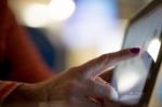 Woman Tapping On Tablet Stock Photo