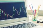 Stock Or Forex Graph In Laptop Screen On Left View On Blue Vintage Style Stock Photo