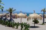 Sun Umbrellas On The Beach At Puerto Banus Stock Photo