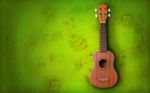 Ukulele On Green Background Stock Photo