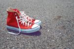 Feet Concept With Red Sneakers On Black Background With Space For Text Or Symbol. Vintage Tone Stock Photo