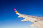 Wing Of The Plane On Blue Sky Background Stock Photo