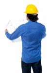 Construction Worker With Blueprint Plan Stock Photo