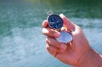 Hand Holding The Black Compass Stock Photo