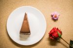 Chocolate Cake On Dish With Flower Stock Photo