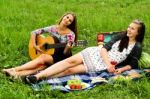 Two Girls With Guitar During Picnic Stock Photo