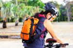 Young Woman Checking Mountain Bike Stock Photo