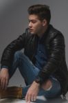 Casual Young Man In Black Leather Jacket And Denim Jeans Stock Photo