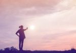 Silhouette Of Woman Praying Over Beautiful Sky Background Stock Photo