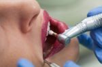 Dentist Curing A Female Patient Stock Photo