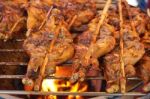 Grilled Chicken Thigh With Herb On The Flaming Grill Stock Photo