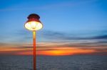 Lighting Of Warm Lamp And Lighting Of Sunset At Sea Stock Photo