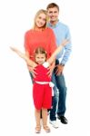 Cheerful Family Of Three Posing Indoors Stock Photo