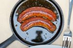 Beef Sausages Cooked On Iron Skillet Stock Photo