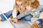Children Turning On Computer Stock Photo
