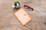 Blank Orange Leather Diary,glasses And A Cup Of Coffee Stock Photo