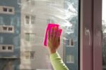 Female Hand Washing A Window Stock Photo