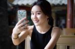 Portrait Of Thai Adult Student University Beautiful Girl Using Her Smart Phone Selfie Stock Photo