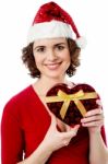 Female Santa With Christmas Gift Stock Photo