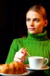 Young Woman Making Breakfast With A Cup Of Cappuccino And Croiss Stock Photo