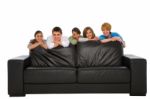 Smiling Teenage Friends With Sofa Stock Photo