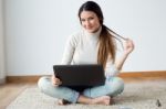 Beautiful Young Woman Working On Her Laptop At Home Stock Photo