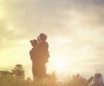 Mother And Daughter On Sunset Watching On Sky Stock Photo