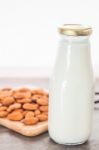 Almond Nuts On Wooden Plate With Milk Stock Photo