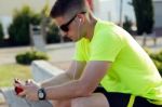 Handsome Young Man Listening To Music After Running Stock Photo