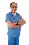 Senior Doctor With Arm Crossed Stock Photo