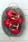 Fresh Pomegranate Fruits Isolated On A White Wooden Background Stock Photo