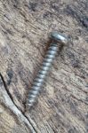 Single Metallic Screw Stock Photo