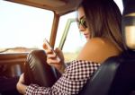 Fashion Beautiful Girl Using Her Mobile Phone In The Car Stock Photo