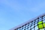 Closeup Tennis Net And Ball With Blue Sky Stock Photo