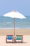 Beach Chairs And White Umbrella Stock Photo