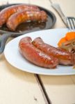 Beef Sausages Cooked On Iron Skillet Stock Photo