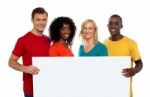 Smiling friends holding blank board Stock Photo