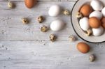 Chicken And Quail Eggs On The White Wooden Table Stock Photo