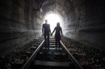 Couple Walking Together Through A Railway Tunnel Stock Photo