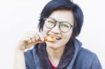 Asian Woman Eating Delicious Chicken Stock Photo