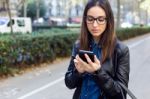 Beautiful Young Woman Using Her Mobile Phone In The Street Stock Photo