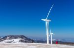 Wind Turbine And Blue Sky In Winter Landscape Stock Photo